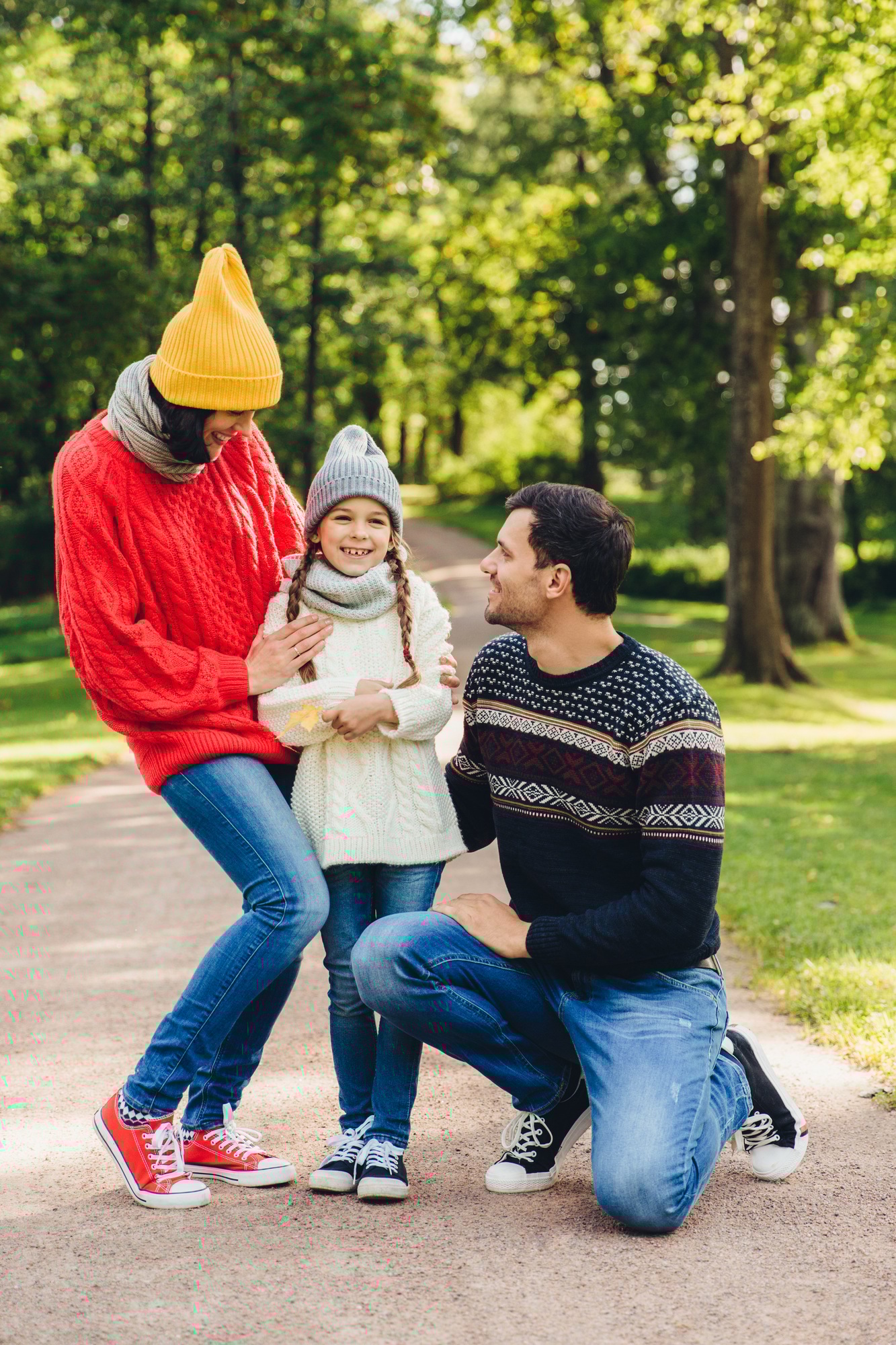 Adorable small cute child being glad to be supported by parents