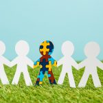 special kid with autism among another on blue and green background